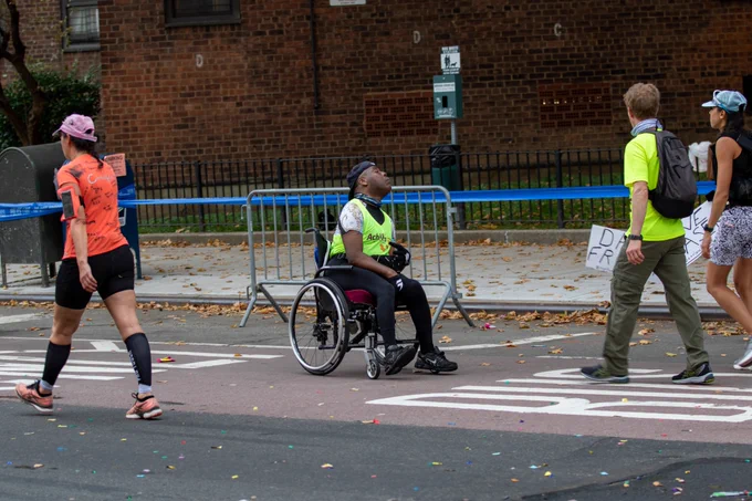 Dave Fraser in a wheelchair competing in the NYC Marathon. Photo by Sam Rubin.