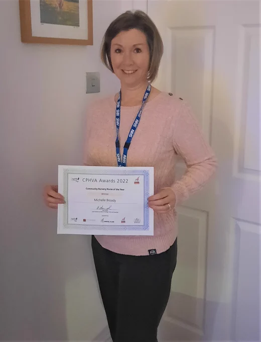 Michelle Broady, volunteer coordinator, with her certificate