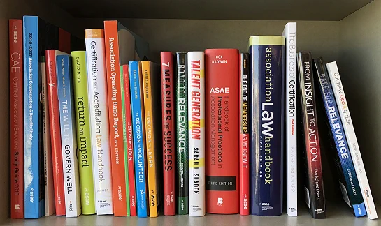bookshelf with several books available in the ASAE bookstore.