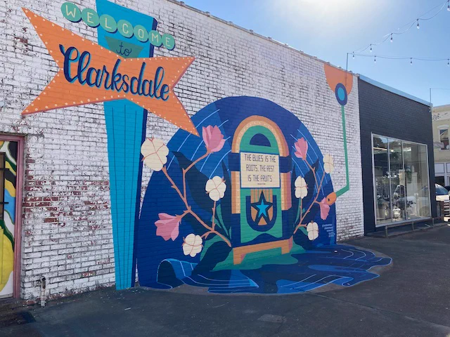 Clarksdale, Mississippi, USA, street art painting on building, jukebox with flowers, a star, record that drapes on street. Quoting: The blues is the roots, the rest is the fruits.