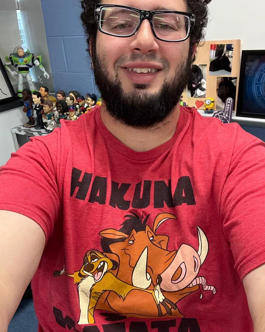 Mr. Shore wearing a shirt with Lion King characters Timon and Pumba saying “Hakuna Matata.”