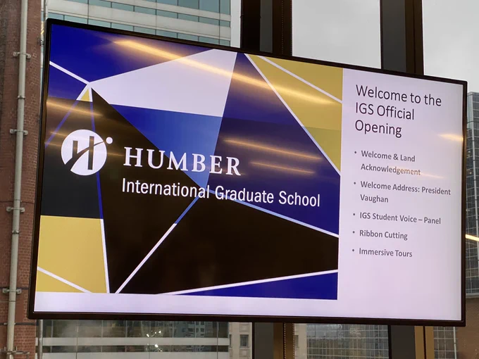A tv screen showing the Humber International Graduate School’s Official Opening’s agenda for the evening.