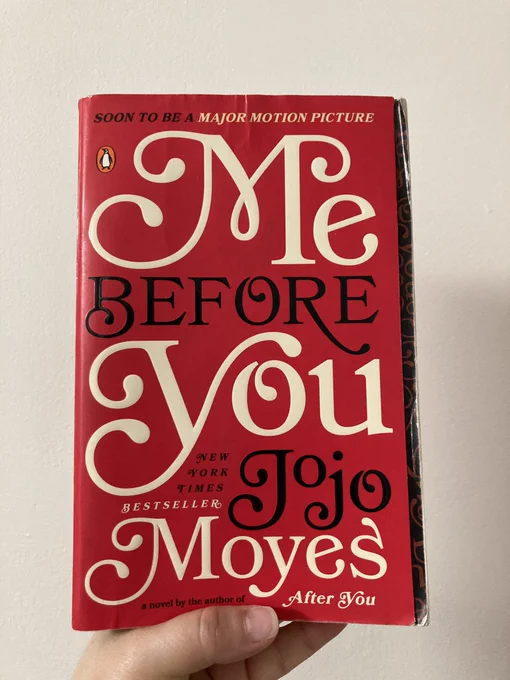 Paperback book cover of Jojo Moyes’s Me Before You. The title and author’s name are written in a curly script on a bright red background.