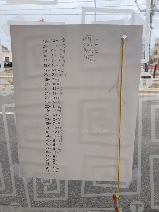 Approximately 3/4 of the subtraction problems from before now have answers written in pencil, and there are now four new problems handwritten into the white space: two square roots, a product and a quotient.