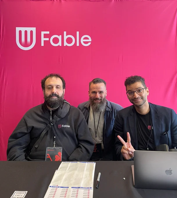 Sam Proulx, Craig Salsa, and Huey Coelho pose in front of Fable's exhibit booth backdrop at RGD's Design Thinkers Toronto conference.