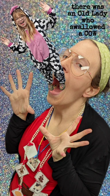 Pic of Ms. Ashlee, dressed as the Old Lady who swallowed a cow, with her mouth wide open pretending to eat a photoshopped pic of Ms. V in a cow costume!