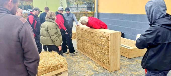 Straw bale building prefabrication workshop with carpentry apprentices.
