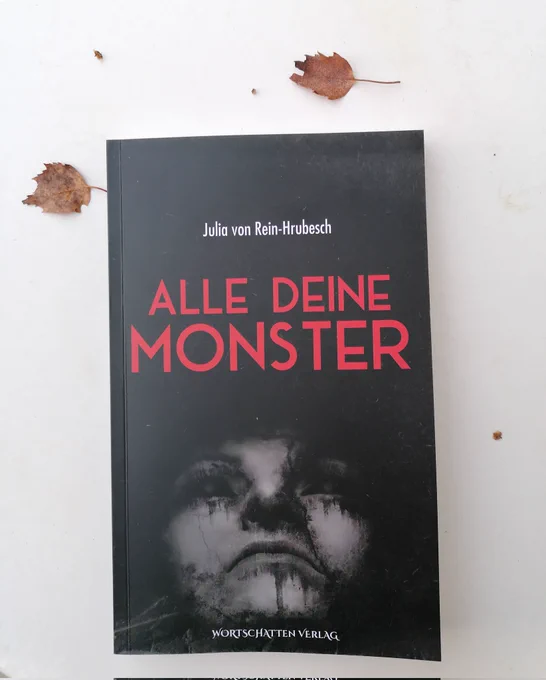 Horror-Roman "Alle deine Monster" von Julia von Rein-Hrubesch, schwarzer Hintergrund, darauf ein Gesicht, das nach oben blickt, Titel in blutrot. 