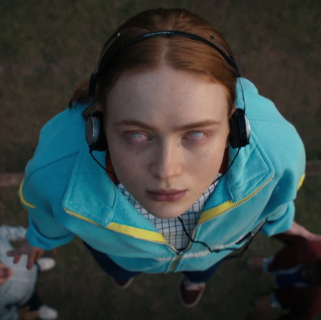 Max Mayfield from Stranger Things under Vecna's spell with headphones on. 
