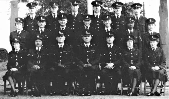 Police training photo from 1954 of officers in dress uniform. Two of the officers are black women.