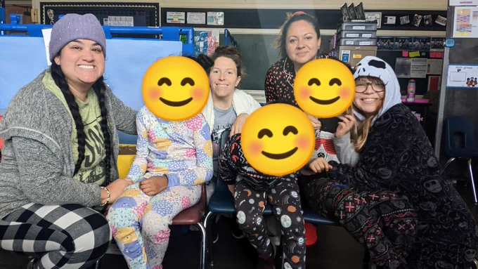3 kids sitting in a row with 2 teachers squatting on each side and 2 teachers behind them. Everyone is wearing their coziest pajamas! Cute smile face emojis are covering the kids faces.
