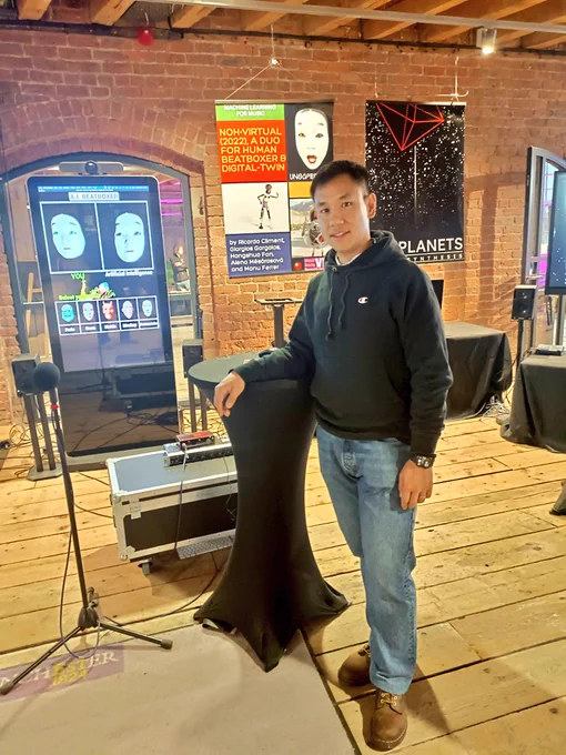 Dr Hongshuo Fan standing in front of the beatboxing interactive project