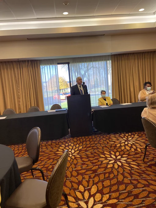 Adelmo stands at the podium
