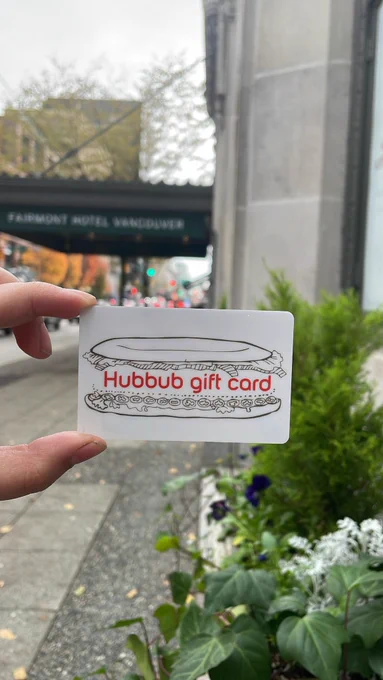 A Hubbub gift card in front of a hotel sidewalk