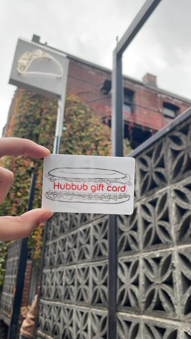 a Hubbub gift card outside of a brick building