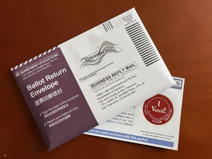 Photo of a ballet return envelop and “I Voted” sticker.