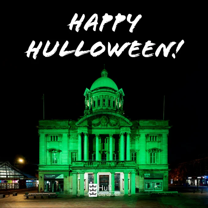 The Hull City Hall lit in a spooky green colour for Halloween. Above the text reads; "Happy Hulloween!".