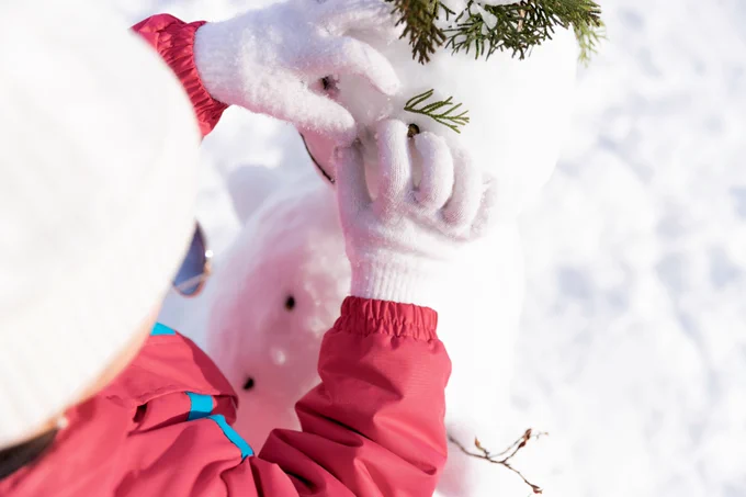 Student building a snowman
