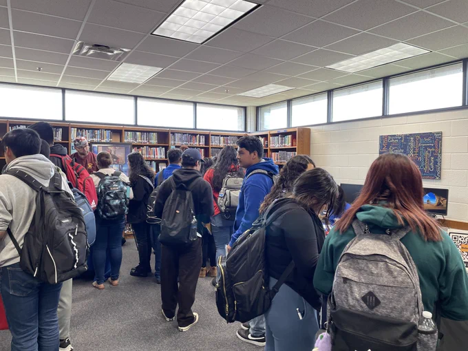 Students talking with local business at a fair. 