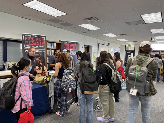 Students talking with local business at a fair. 