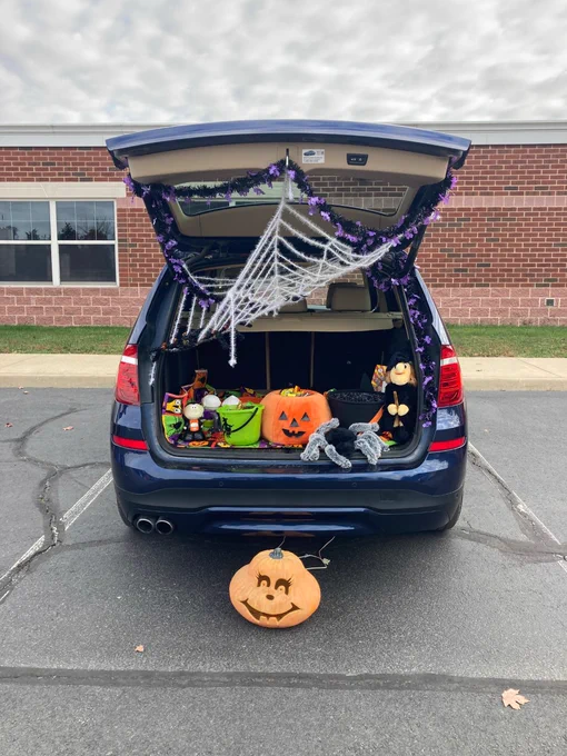 trunk with pumpkins, spider webs and other spooky Halloween decorations