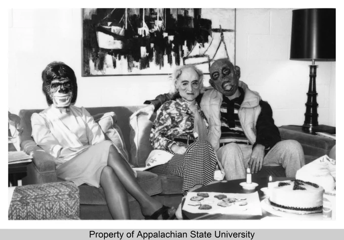 The spectral figures were, in fact,  staff members wearing Halloween masks in the Office of Public Affairs and Development at Appalachian State University in October 1980.