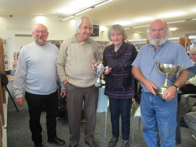 Four members of the Lancashire Dialect Group with trophies