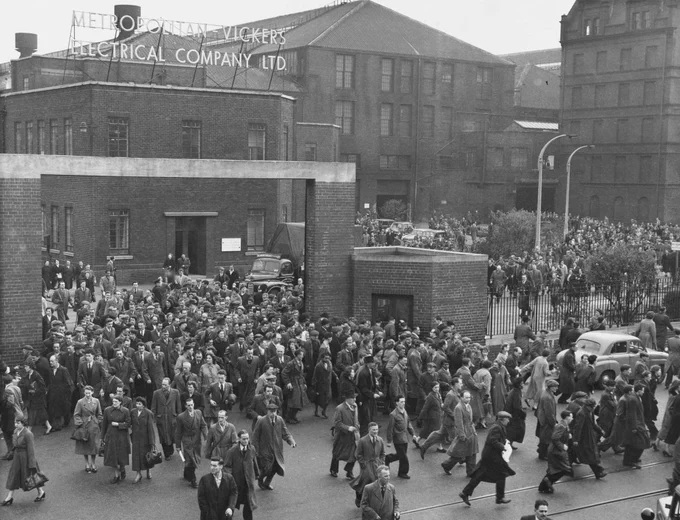 A black and white photo showing crowds of workers leaving the Metropolitan Vickers engineering works in Trafford Park.