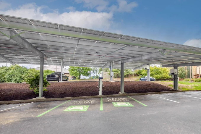 A solar carport provides shade and shelter to parked cars while generating electricity. Two electric vehicle chargers are available to provide clean, renewable energy to parked electric vehicles.