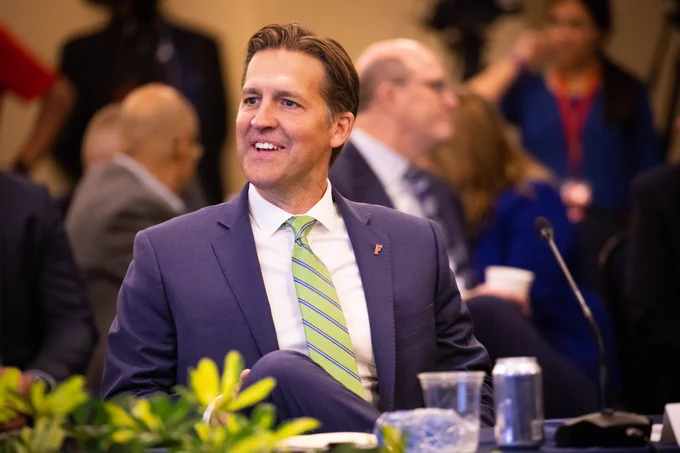 Dr. Ben Sasse looks to his right, smiling, at the UF Board of Trustees Nov. 1 meeting
