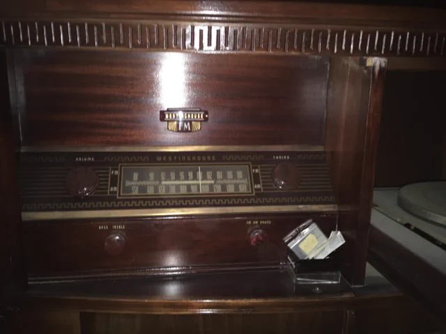 Close-up with the two doors open. On the left, the radio dial and a Westinghouse logo. On the right (mostly out of frame), the turntable for records.