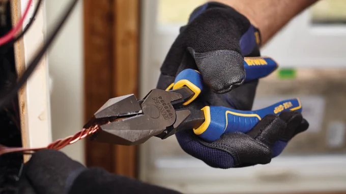 A photo of a man using Vise-Grip® 8-in Electrical Linesman Pliers to cut electrical wire.
