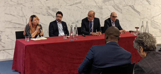Photo of four people sat at the royal society for the royal institute of navigation event on PNT leadership. I’m holding the microphone and sat next to 3 men representing focal point positioning, spirent and cranfield Uni