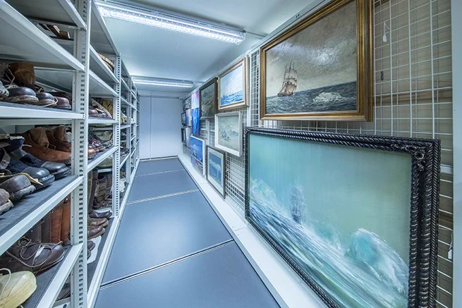 Photography of the museum's storage facility, showing artworks and boots