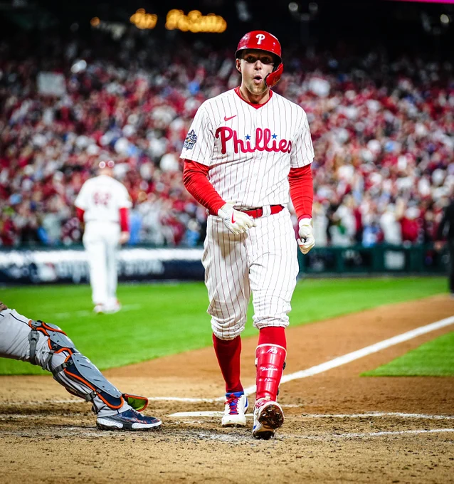 Rhys Hoskins making in a face like "woah I hit that" after hitting a home run. We'd imagine that's what he's thinking at least. He's wearing the red pinstripes uniform.