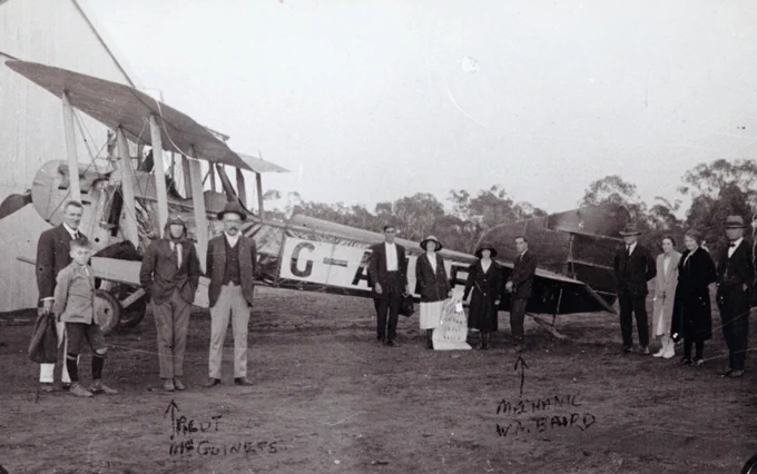 Pilot Paul McGinness (third from L) prepares to depart from Charleville for Longreach on 2 November 1922. The mailbag containing 106 letters is proudly displayed in front of the Qantas FK8 aircraft.