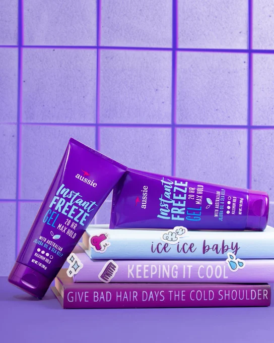 Instant Freeze Gel stacked on top of two purple books reading "A Guide to Keeping it Cool" and "Holding Down: the Cheat Sheet"