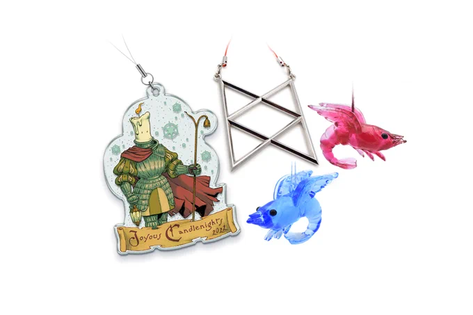 The November McElroy merch items. On the left is an acrylic ornament of a burning candle wearing armor and holding a staff. It says, “Joyous Candlenights 2022”. Top center is a silver metal ornament of the BoB symbol. Bottom center is a translucent glass blue shrimp with wings ornament. To the right is a translucent glass red shrimp with wings ornament.