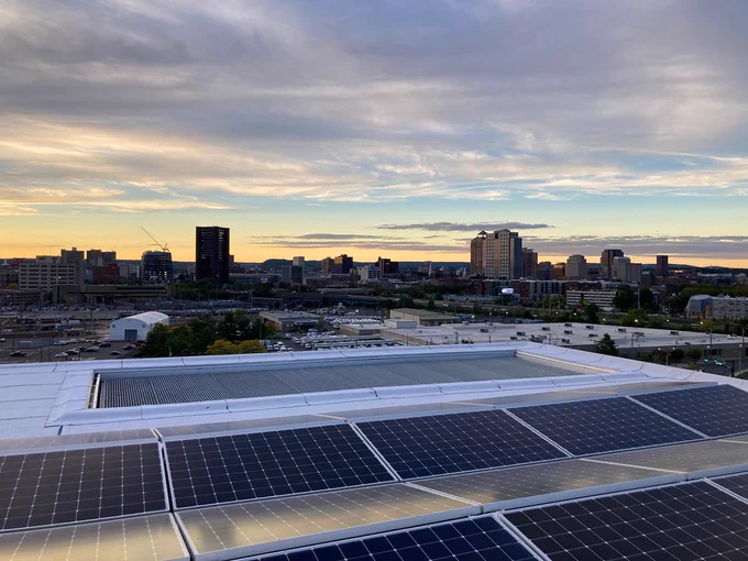 Solar panels on the roof of Hotel Marcel with the New Haven skyline in the background.