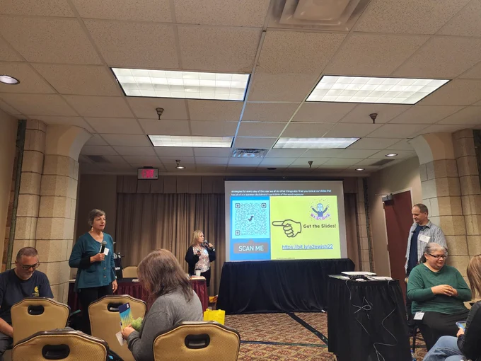 Picture of presenters and presentation. 