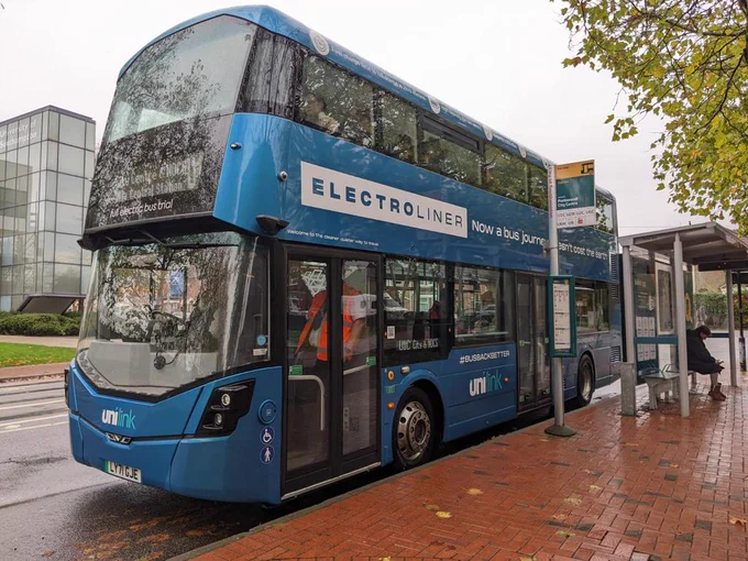 Blue electric double decker bus at a bus stop, 'electroliner'