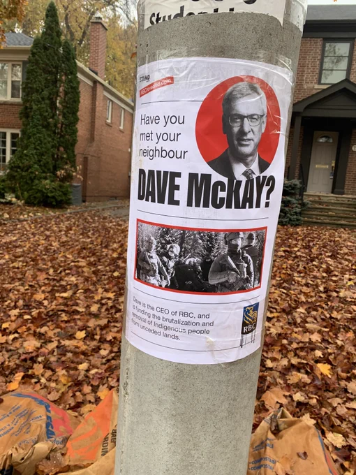 A poster that read have you met your neighbour Dave McKay on a pole 