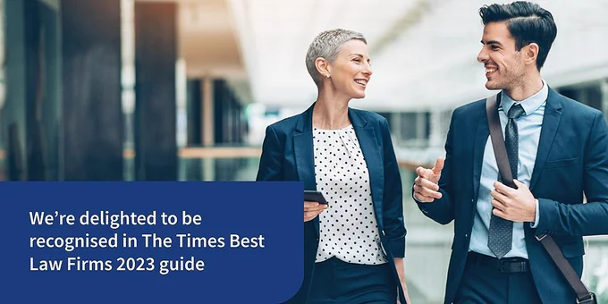 An image of two business people talking. The text reads "We're delighted to be recognised in The Times Best Law Firms 2023 guide."