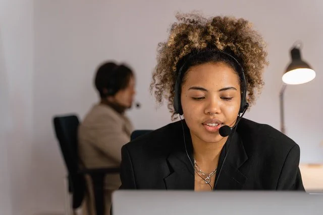 Image of a woman in an office using a handsfree headset 