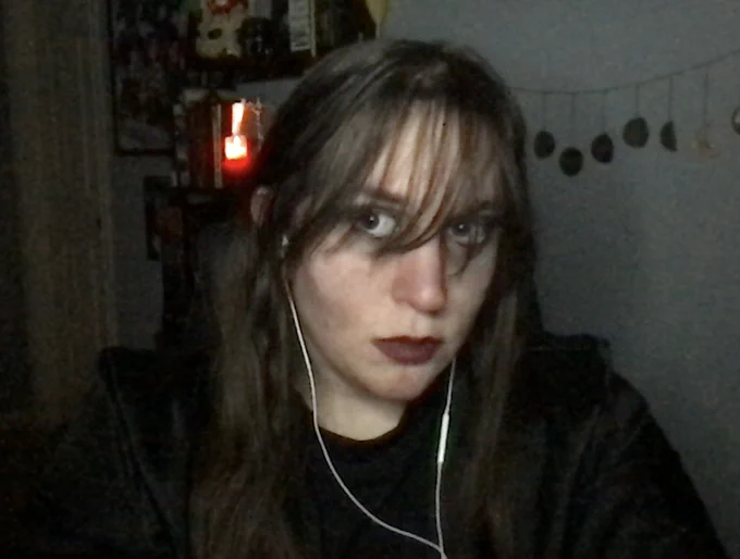 A selfie of me with dark circles and my hair in my face. Hollow cheeks as well.