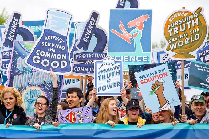 Crowd holds banner and signs at the March for Science in Washington DC, 2017