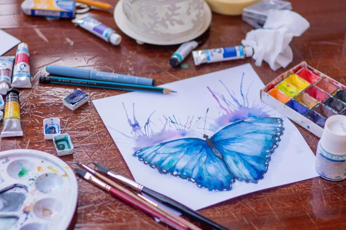 art supplies and painting of a butterfly