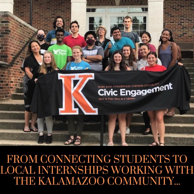 Photo of a group of students and CCE staff standing on stairs in front of a building. Group is holding a sign at the front which has the Center for Civic Engagement logo on it.