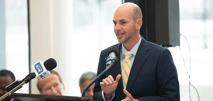 A man speaks at a podium.