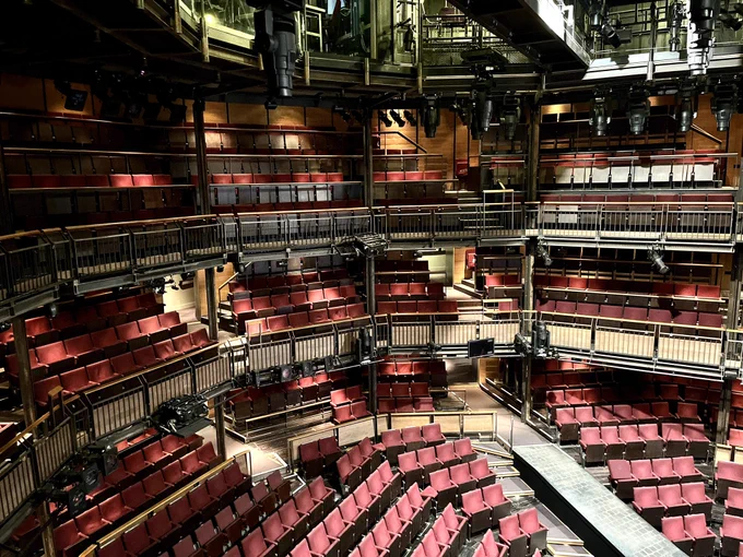 A theatre auditorium has red seats